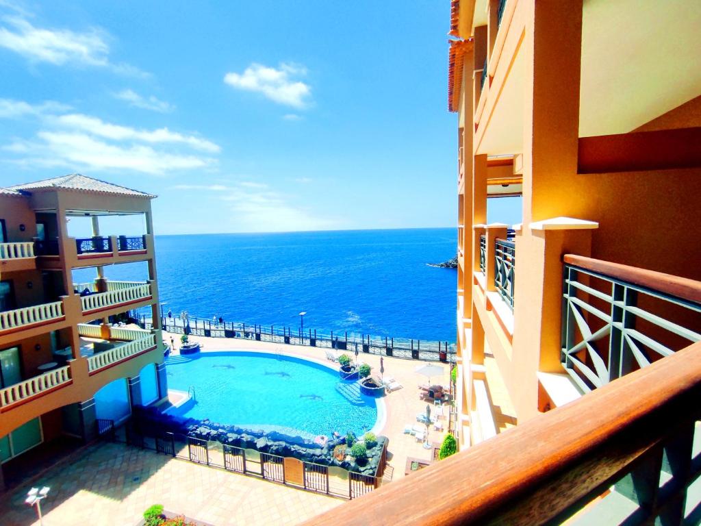 a view of the ocean from a balcony of a hotel at El Nautico Suites, Golf del Sur in San Miguel de Abona