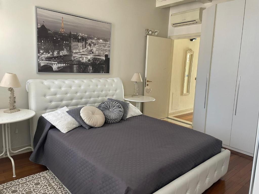 a bedroom with a large bed with pillows on it at La Suite di Giulia in Ferrara