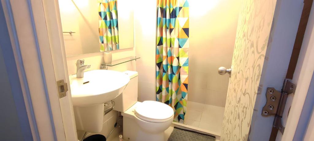 a small bathroom with a toilet and a sink at Aveline Suites Executive City View ACQUA Private Residences near Rockwell Makati in Manila