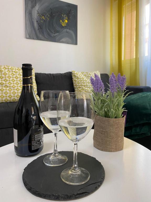 a table with two wine glasses and a bottle of wine at SOL Lux Apartments 1st Floor in Durrës