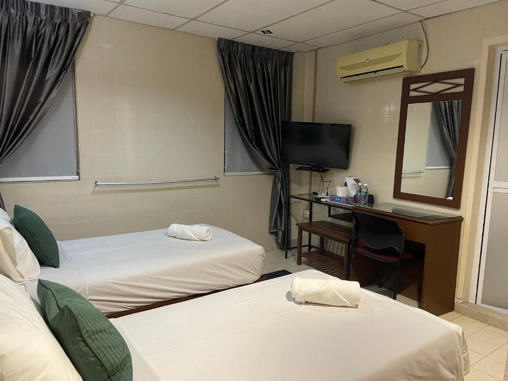 Postel nebo postele na pokoji v ubytování Barrack Street Hotel