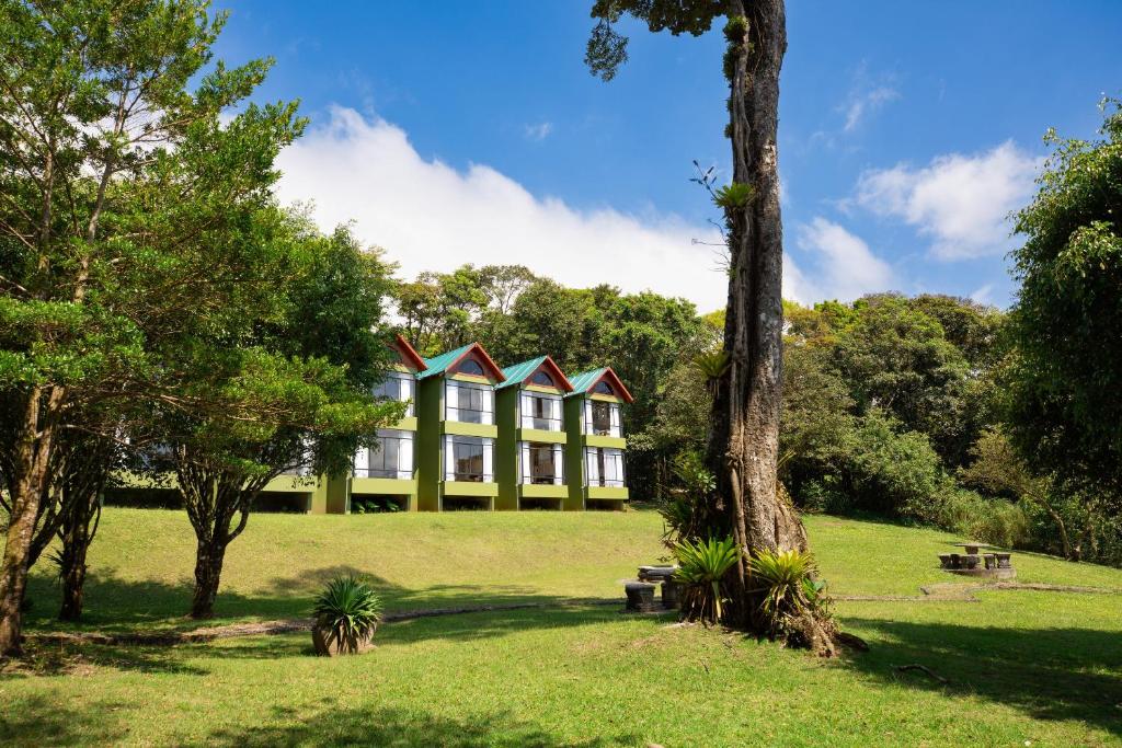 a house in the middle of a park with trees at Fondavela Hotel in Monteverde Costa Rica