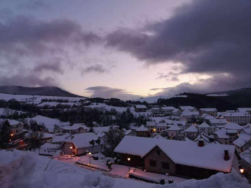 a town covered in snow at night with the sky at Casa Jabarde in Jaurrieta