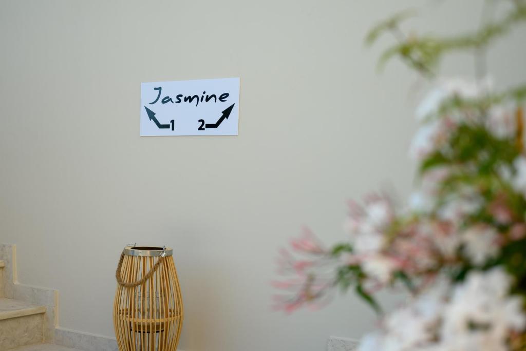 a vase sitting next to a wall with a sign at Jasmine loft luxury 1 in Kokkini Khanion