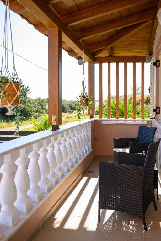 a balcony with chairs and a white railing at Jasmine loft luxury 1 in Kokkini Khanion
