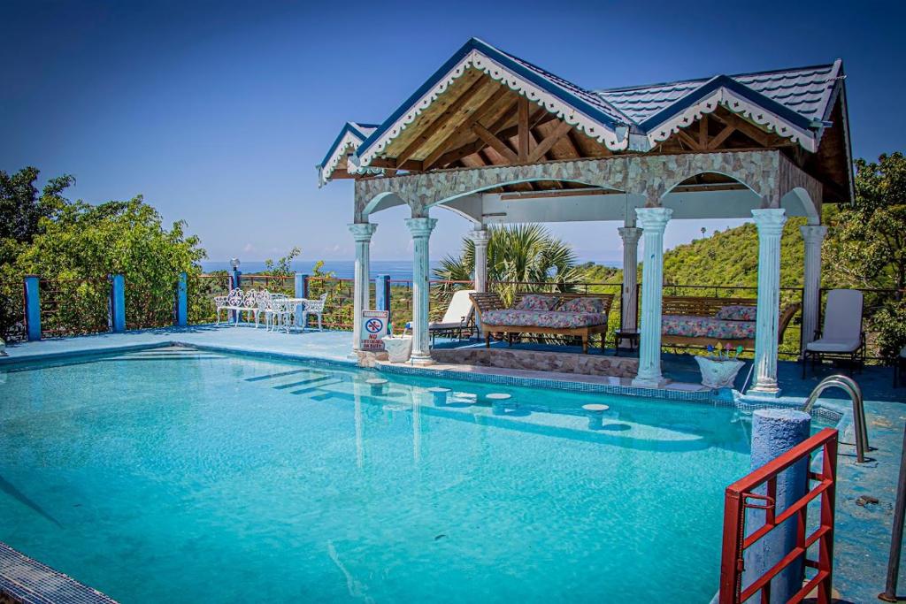 a swimming pool with a gazebo at Kassion Corner in Whitehouse