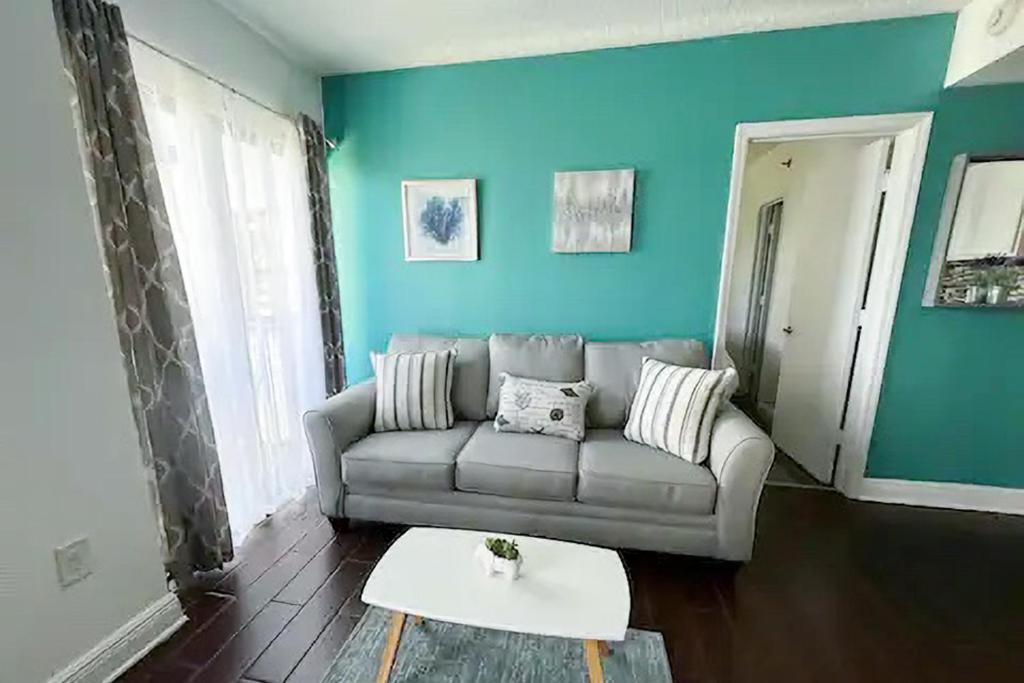 a living room with a couch and a table at The Enclave - Unit 1601 in Orlando