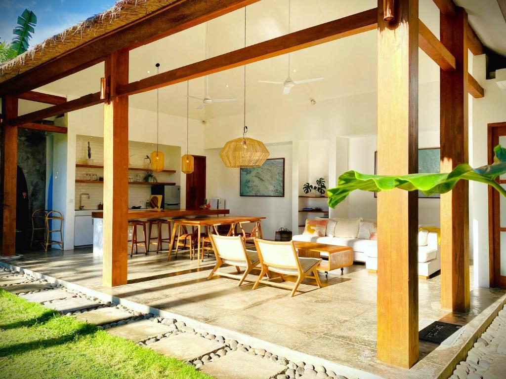 an open living room and dining room with a table and chairs at SUNDAY Villa with private pool, near centre and beach in Kuta Lombok