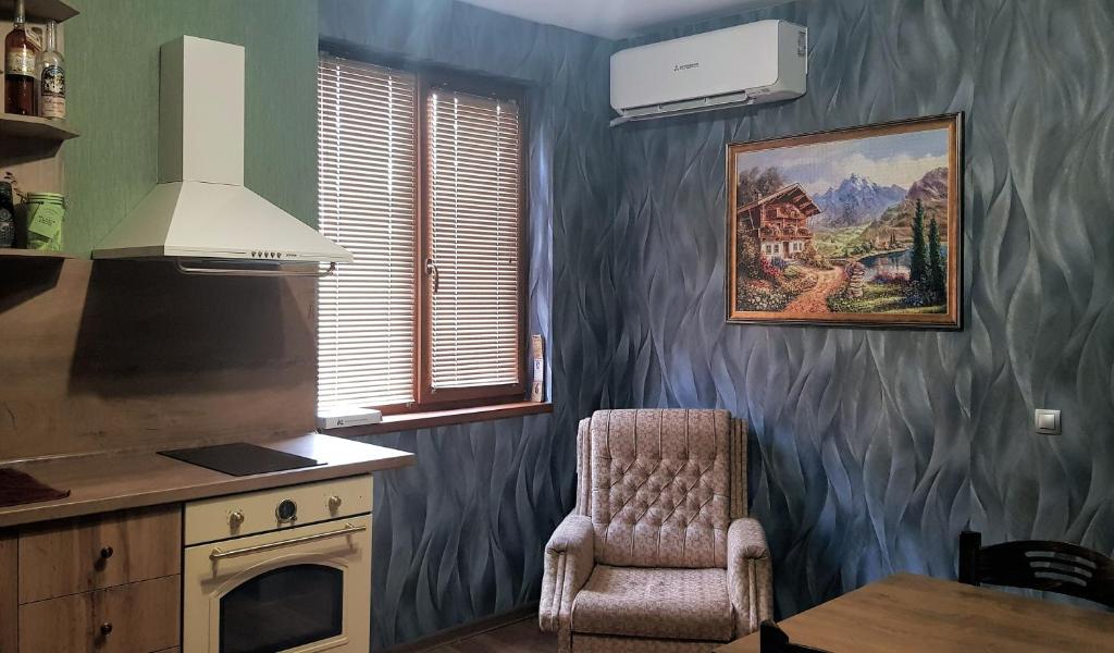 - une cuisine avec une cuisinière et une chaise dans la chambre dans l'établissement Дионея, à Belogradchik