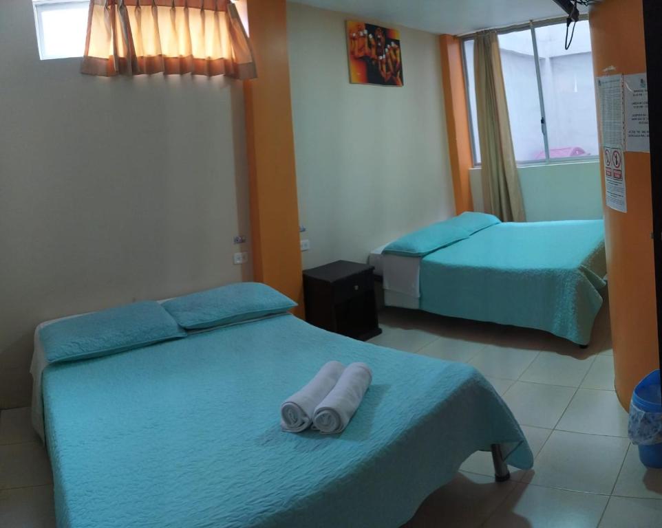 Postel nebo postele na pokoji v ubytování Hostal Bryana Inn Baños