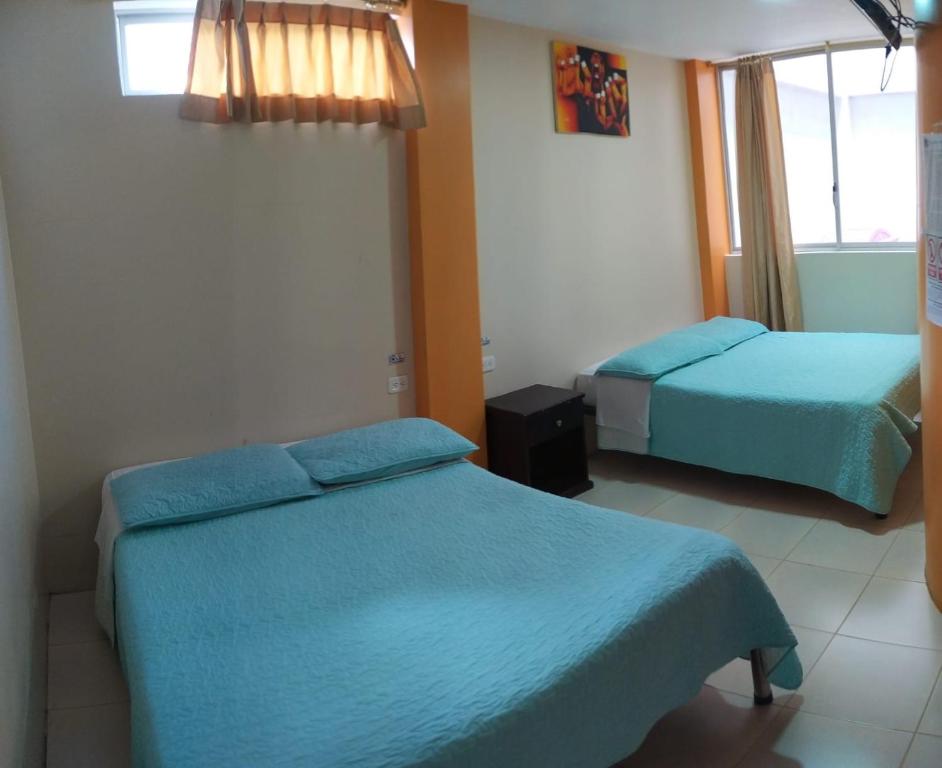 Postel nebo postele na pokoji v ubytování Hostal Bryana Inn Baños