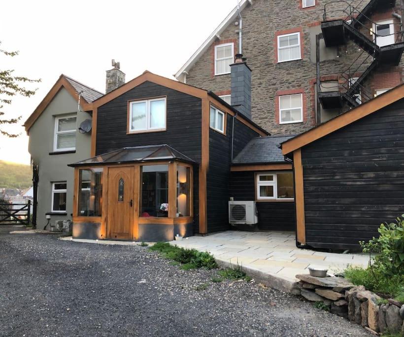 a house with a wooden door and a driveway at Spacious 4-Bed House in Lynton in Lynton