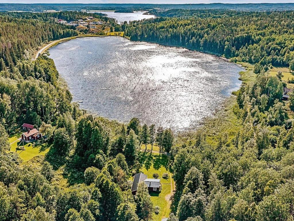 an aerial view of a house and a lake at Lakefront Cottage in Torsebo in Askersund