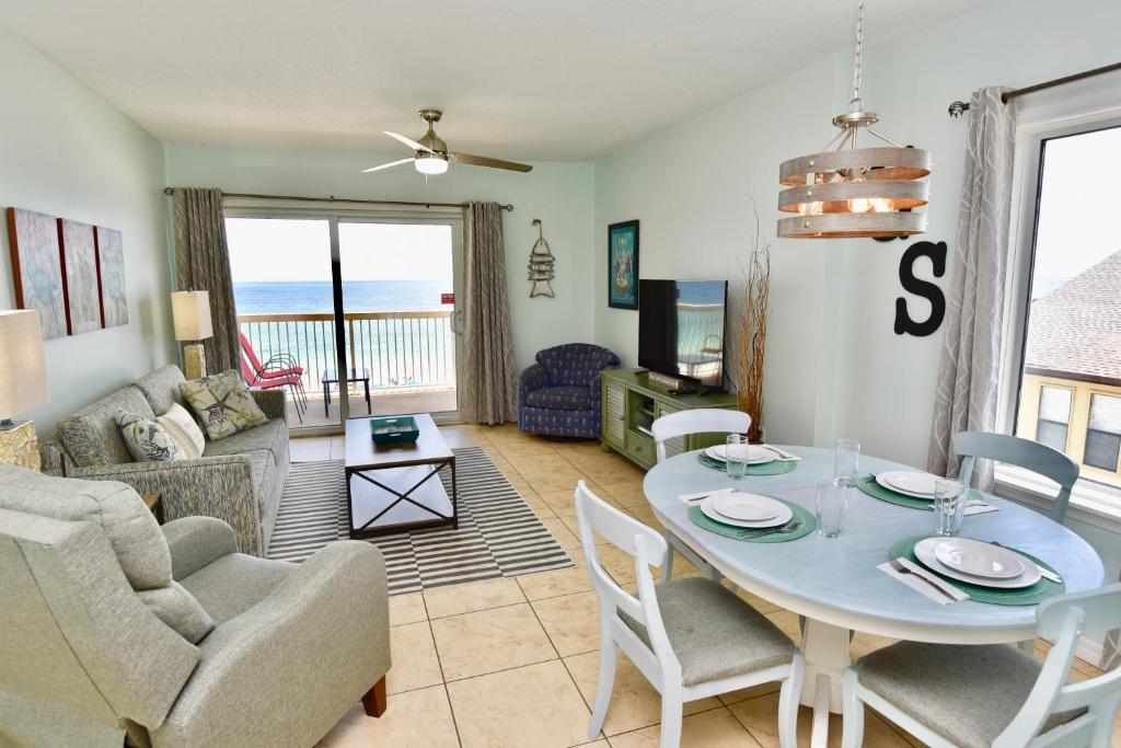 a living room with a table and chairs at Caribbean 404 in Gulf Shores