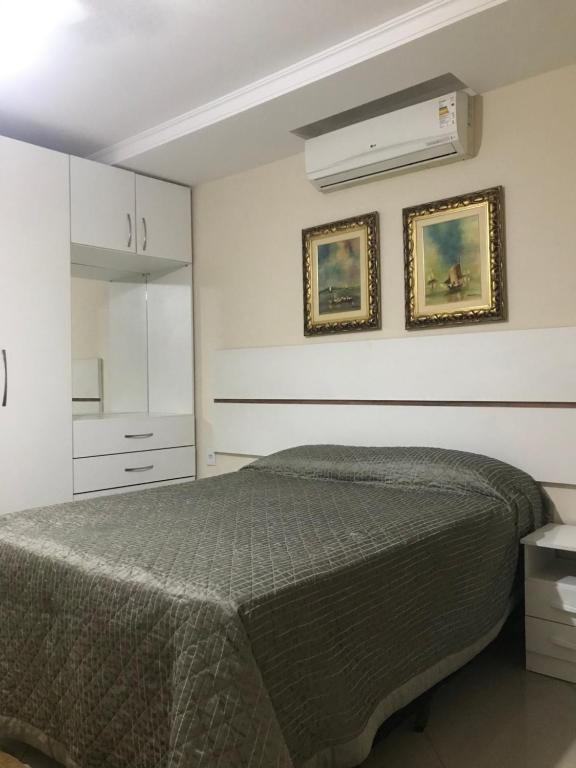 a bedroom with a bed and a white cabinet at Pousada Casa do Jova em Raposo RJ 