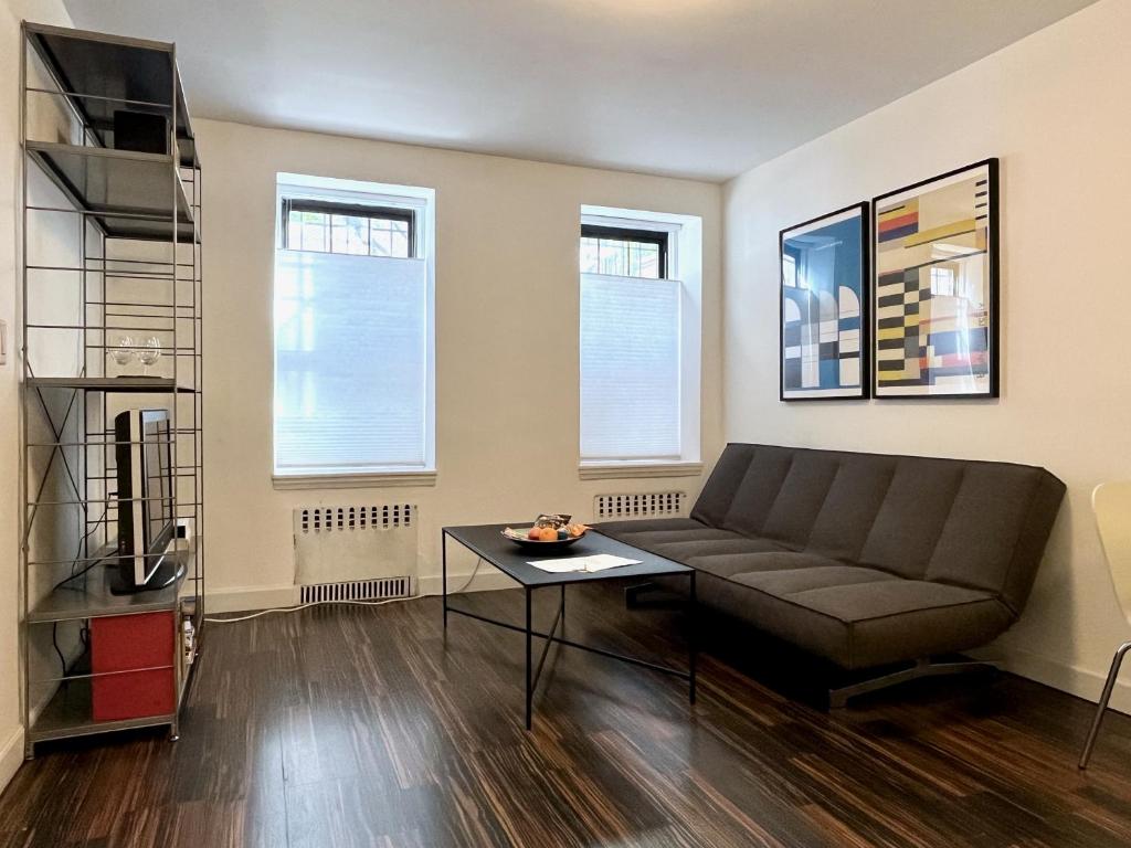 un soggiorno con divano e tavolo di Close to all! 2-room suite in a 1-family townhouse a Brooklyn