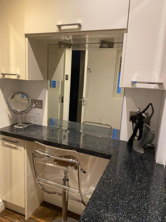 a bathroom with a sink and a mirror at Balcony House Apartment in Kendal in Kendal