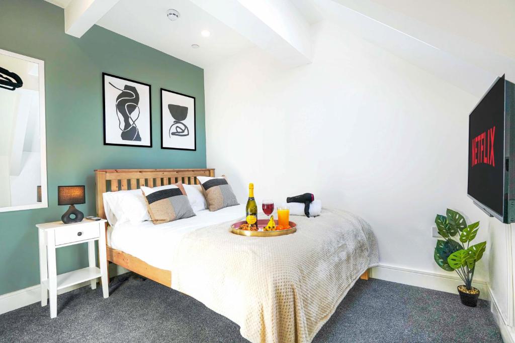 a bedroom with a bed with a table on it at Central Buckingham Apartment #1 with Free Parking, Pool Table, Fast Wifi and Smart TV with Netflix by Yoko Property in Buckingham