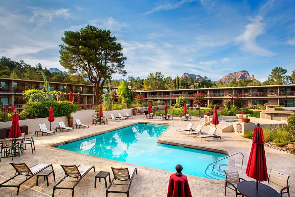 a hotel with a pool and chairs and a resort at Arabella Hotel Sedona in Sedona