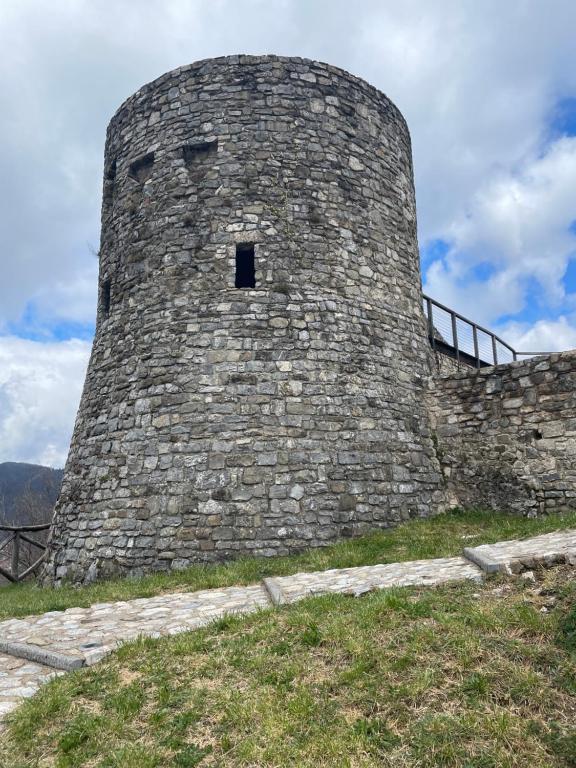 a large stone building with a window on a hill at In Castello in Gallicano