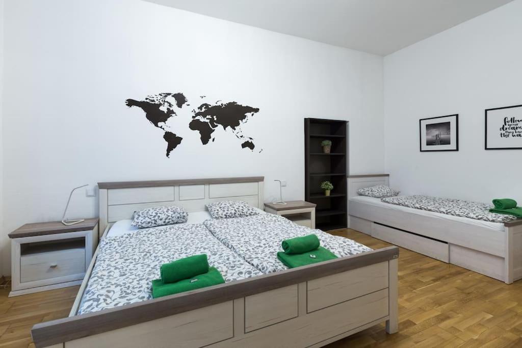 a bedroom with two beds with a world map on the wall at Relax Apartment Vienna City Center in Vienna