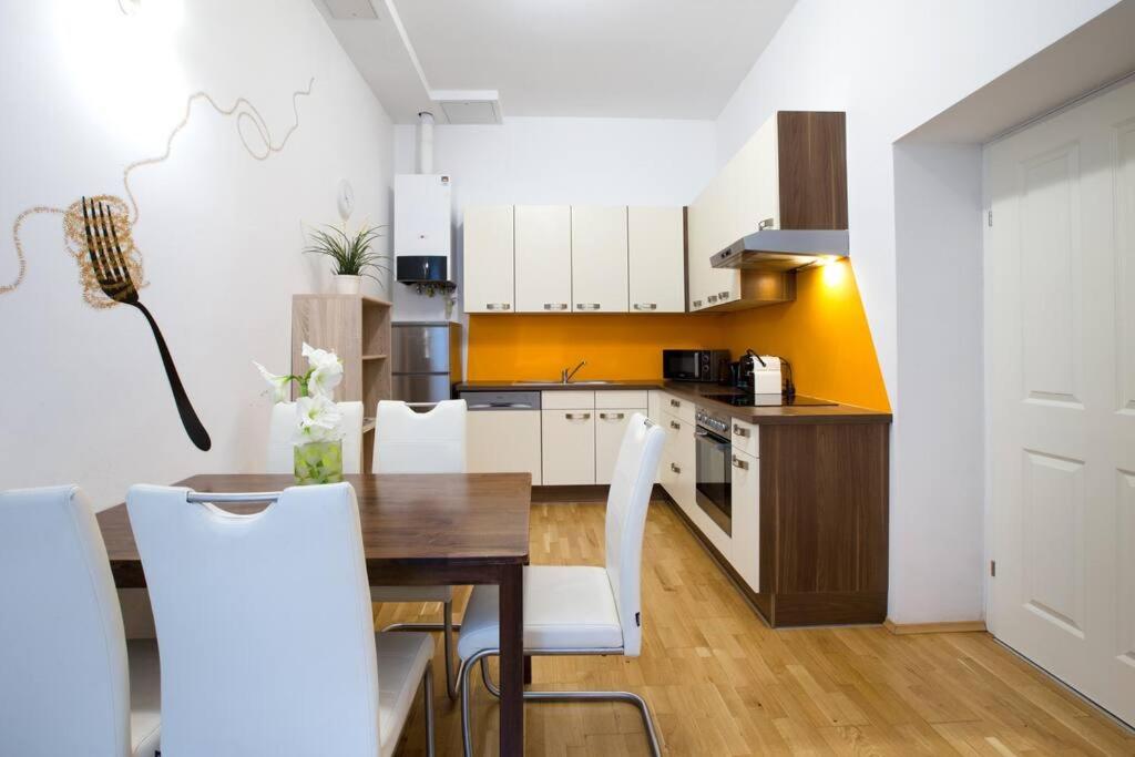 a kitchen and dining room with a table and chairs at Relax Apartment Vienna City Center in Vienna