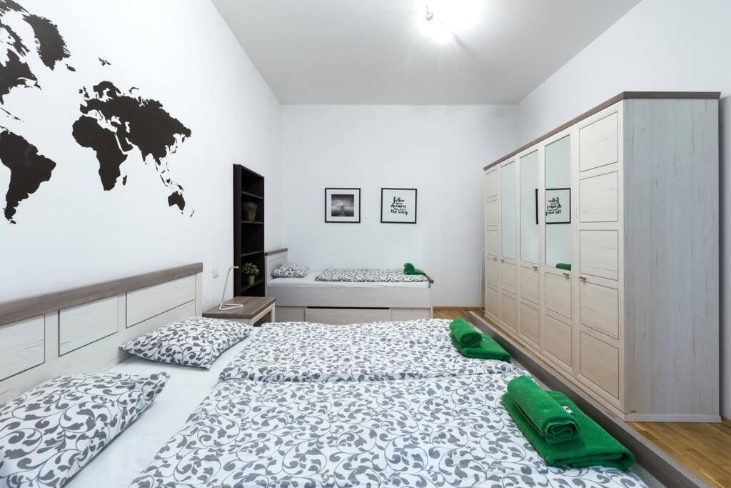 a bedroom with a large bed and a world map on the wall at Relax Apartment Vienna City Center in Vienna