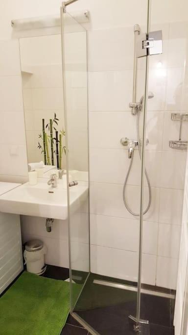 a bathroom with a glass shower and a sink at Relax Apartment Vienna City Center in Vienna