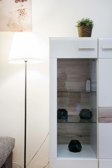 a white cabinet with a plant on top of it at Relax Apartment Vienna City Center in Vienna