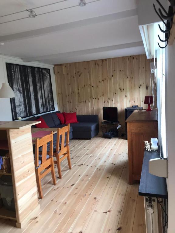 a living room with a couch and a table at Le chalet bungalow zéro check in - out in Ortho