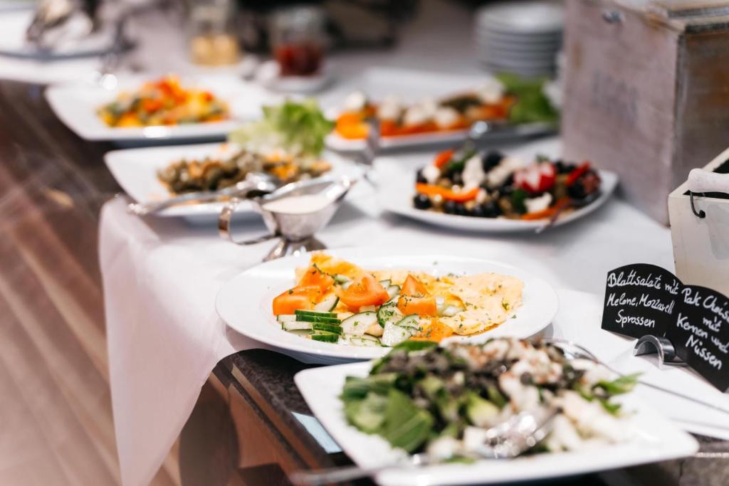 a buffet with plates of food on a table at City Park Hotel in Frankfurt Oder