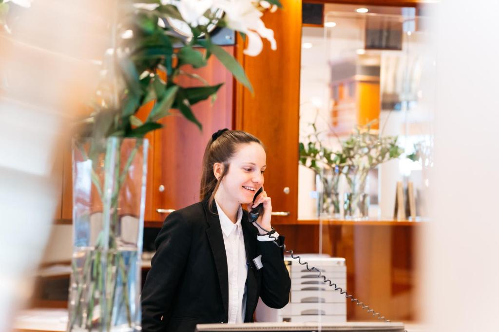 a young girl talking on a cell phone at City Park Hotel in Frankfurt Oder