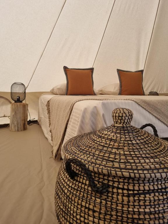 a bedroom with a bed and a table in a tent at Camping les lodges du Tarn in Mostuéjouls