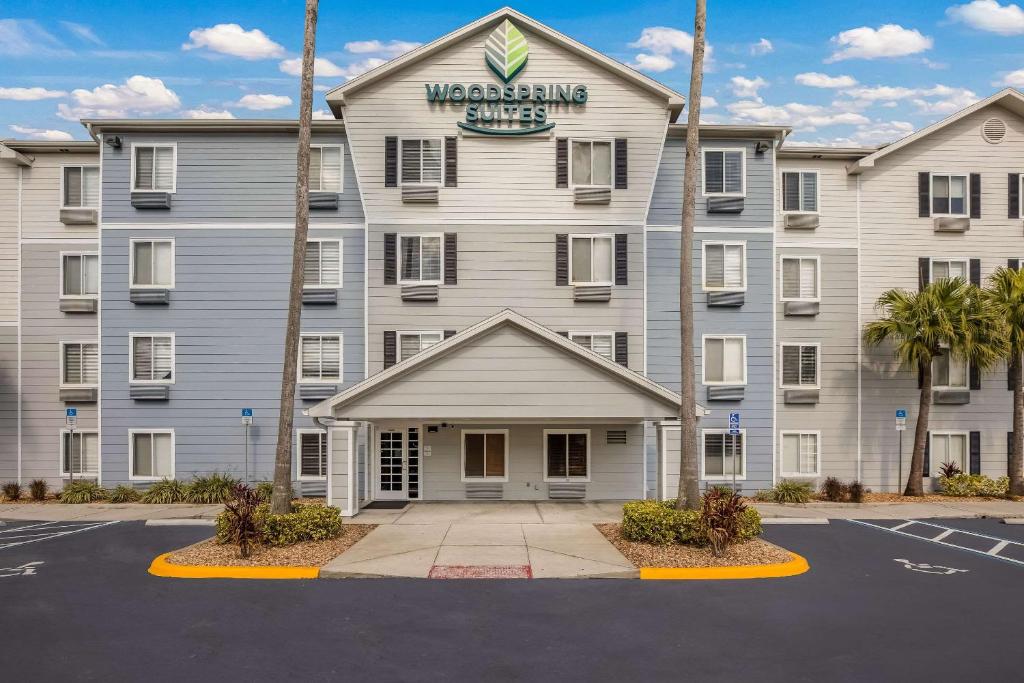 a large building with a sign on the front of it at WoodSpring Suites Orlando North - Maitland in Orlando