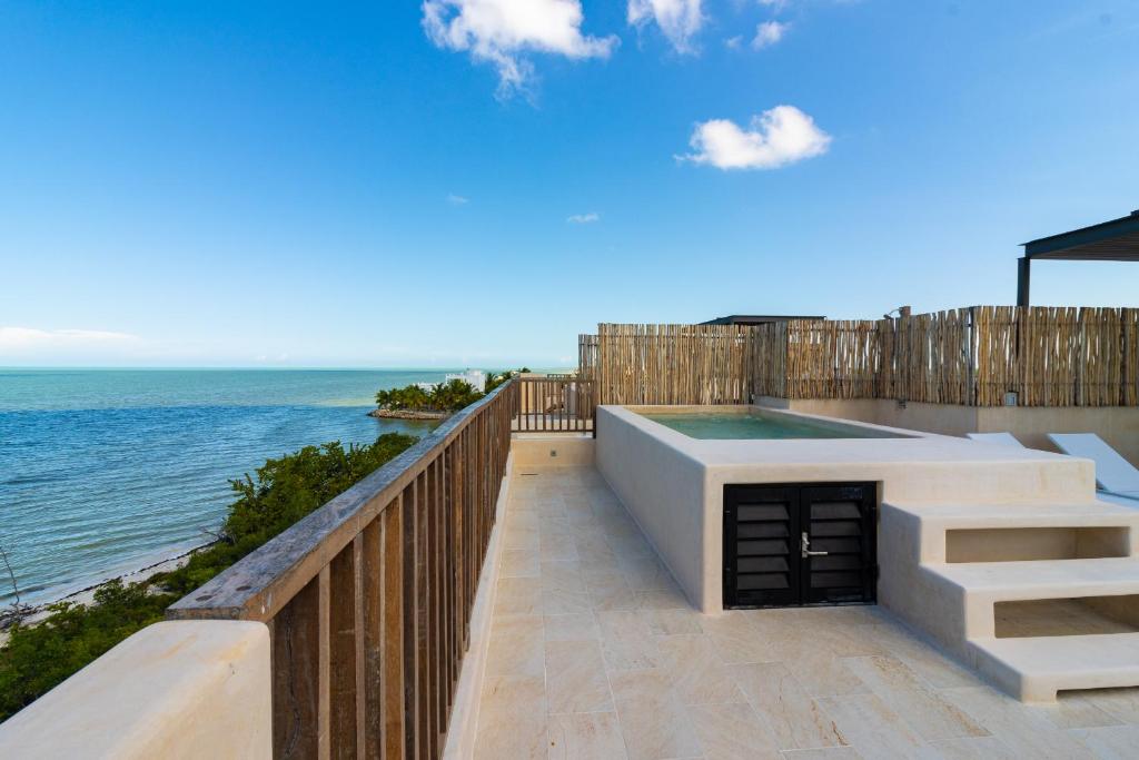 a balcony with a swimming pool and the ocean at Beautiful Ocean View Penthouse With Private Pool -C301 in Holbox Island