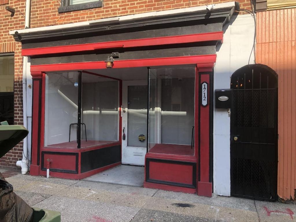 a red and white building with a red door at Private romantic apartment in fellspoint 2min from fellspoint night bars in Baltimore