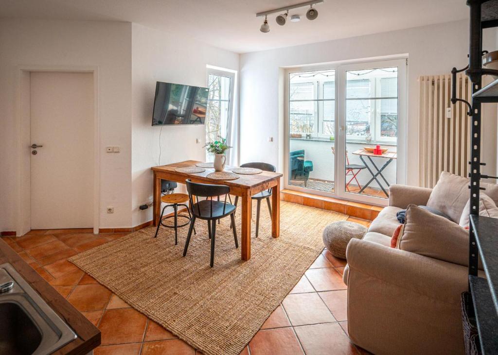 a living room with a table and a couch at 3-Raum-Appartement Hygge in Sassnitz