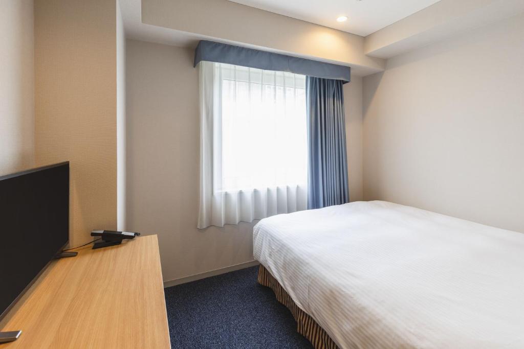 Postel nebo postele na pokoji v ubytování Sotetsu Fresa Inn Tokyo-Akasaka