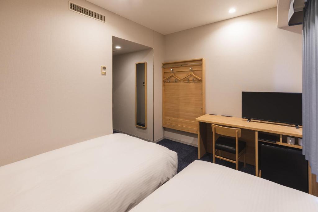 Postel nebo postele na pokoji v ubytování Sotetsu Fresa Inn Tokyo-Akasaka