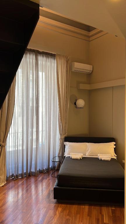 A bed or beds in a room at Duomo Housing Catania Le Suites