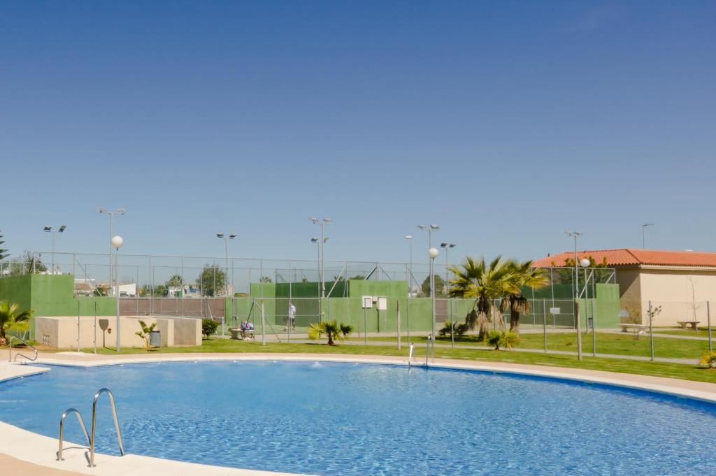 a large swimming pool in front of a building at Apartamentos Sanlúcar &amp; Doñana in Sanlúcar de Barrameda