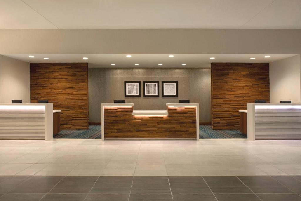 a lobby of a hotel with a reception desk at Tulsa Marriott Southern Hills in Tulsa