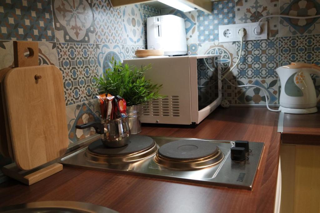 a kitchen with a stove and a microwave at Mirage Apartments Váci Street in Budapest