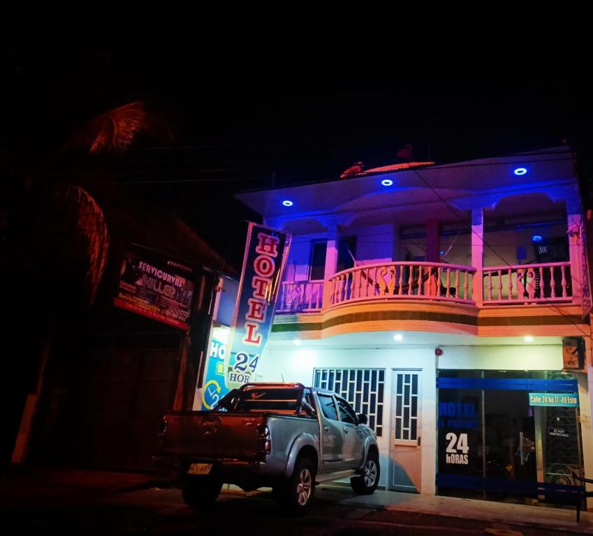 a truck parked in front of a building at night at Hotel El Paisano in Villavicencio