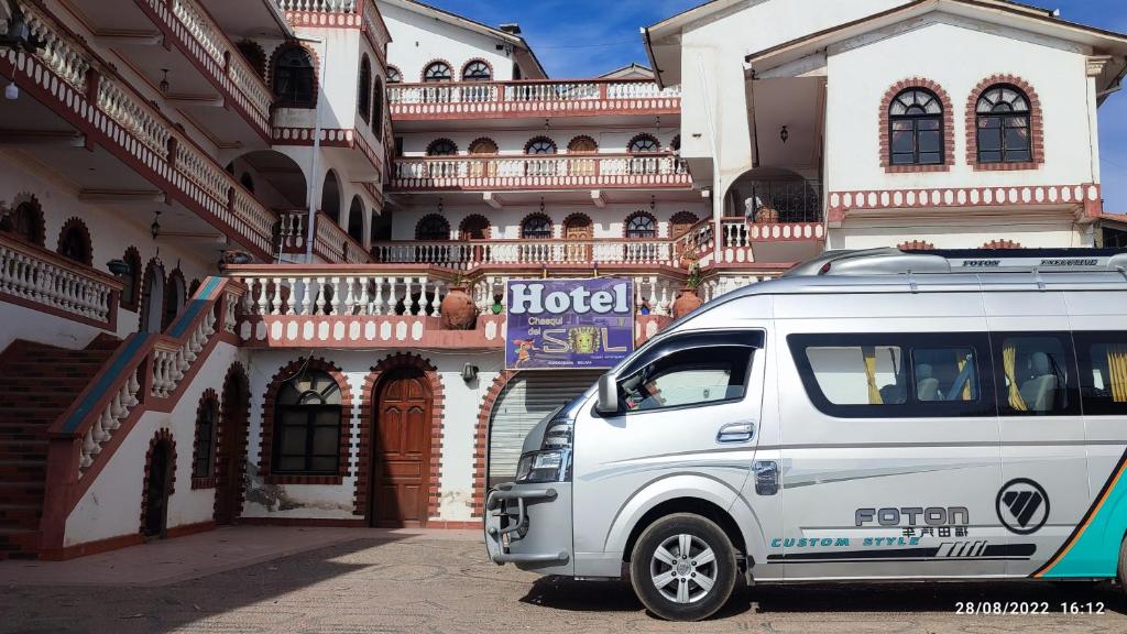 a white van parked in front of a building at Hotel Chasqui del Sol in Copacabana