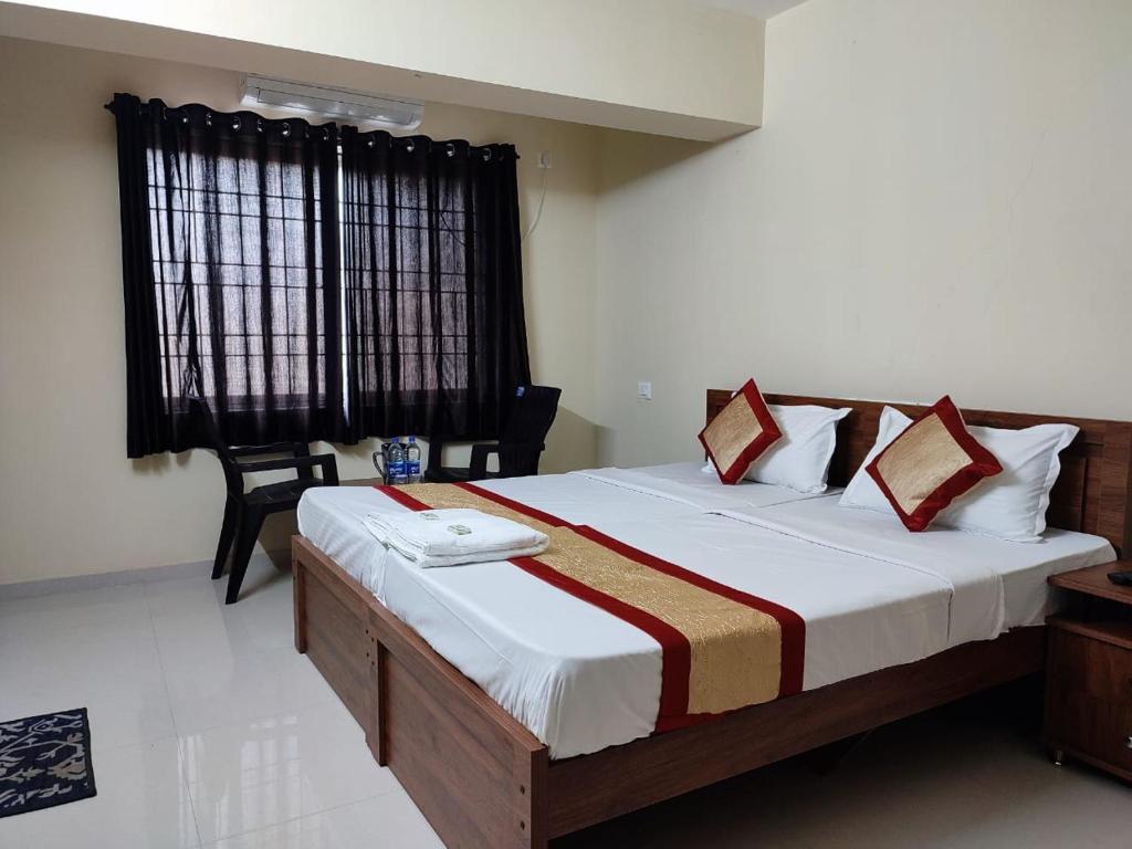 a bedroom with a large bed in a room at PREMIER INN LODGE in Mangalore