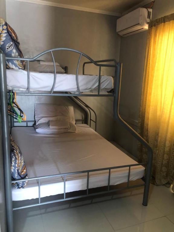 two bunk beds in a room with a window at LP Madriaga Private Apt fully furnished w/Balcony in Ayusan Norte