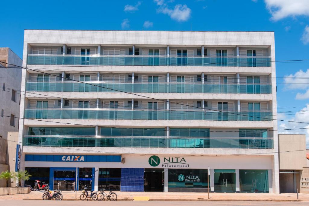 an office building with a nitta sign in front of it at Nita Palace Hotel in Pompeu