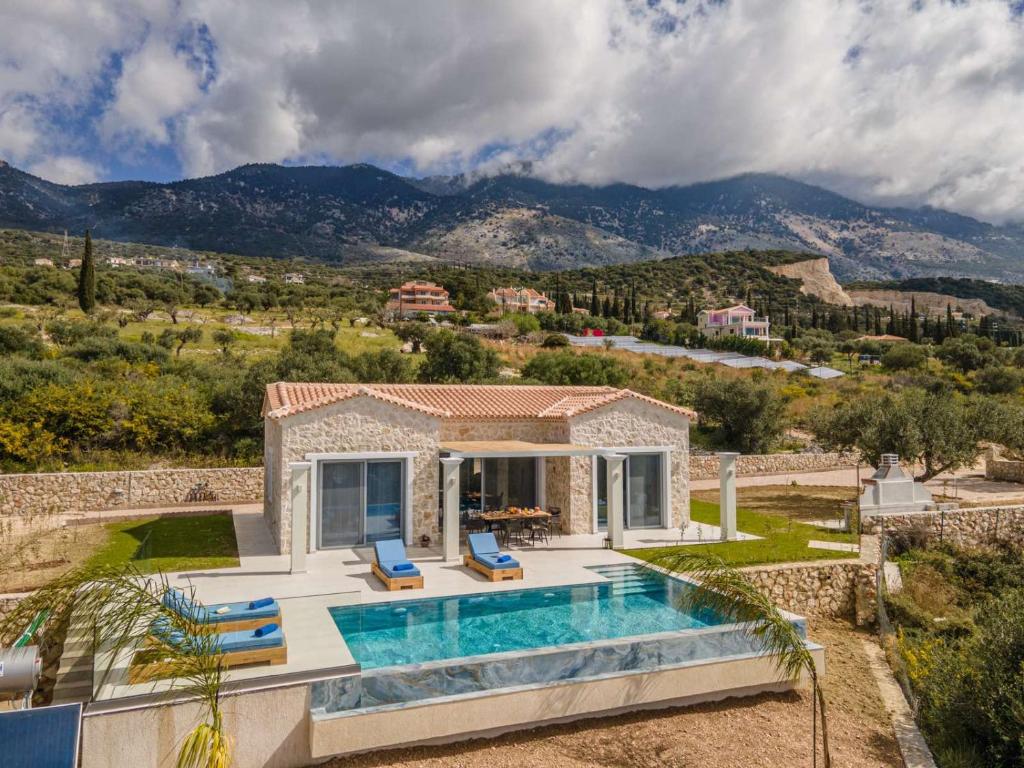 a villa with a swimming pool and a house at Natural Stone Villas Kefalonia in Trapezaki