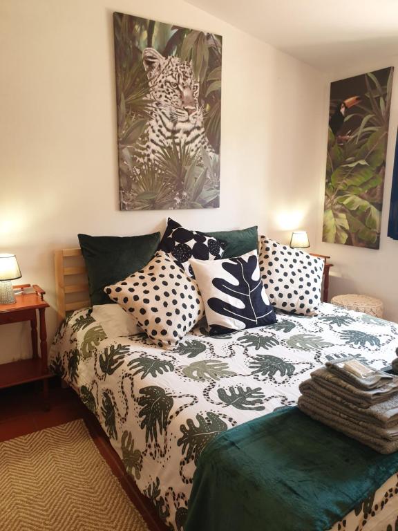 um quarto com uma cama com almofadas em Sondela Self Catering em São Martinho do Porto